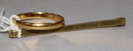 A 22ct gold band and a 9ct tie pin.