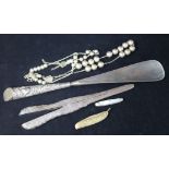 A silver handled shoe horn, silver glove stretchers, beads, etc.