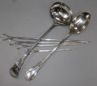 A silver plated ladle, serving spoon and four graduated skewers