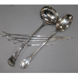 A silver plated ladle, serving spoon and four graduated skewers