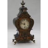 A German mantel clock in carved burr walnut and ebonised shaped case with gilt metal mounts