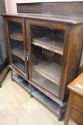 A 1920's glazed two door bookcase, W.120cm