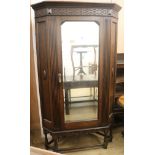 A carved oak corner wardrobe H.200cm