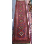 A persian red ground runner, 250 x 62cm