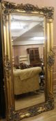 A large gilt moulded framed wall mirror, W.184cm