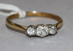 An 18ct gold and three stone diamond ring, size Q.