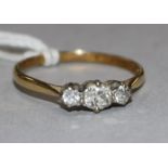 An 18ct gold and three stone diamond ring, size Q.