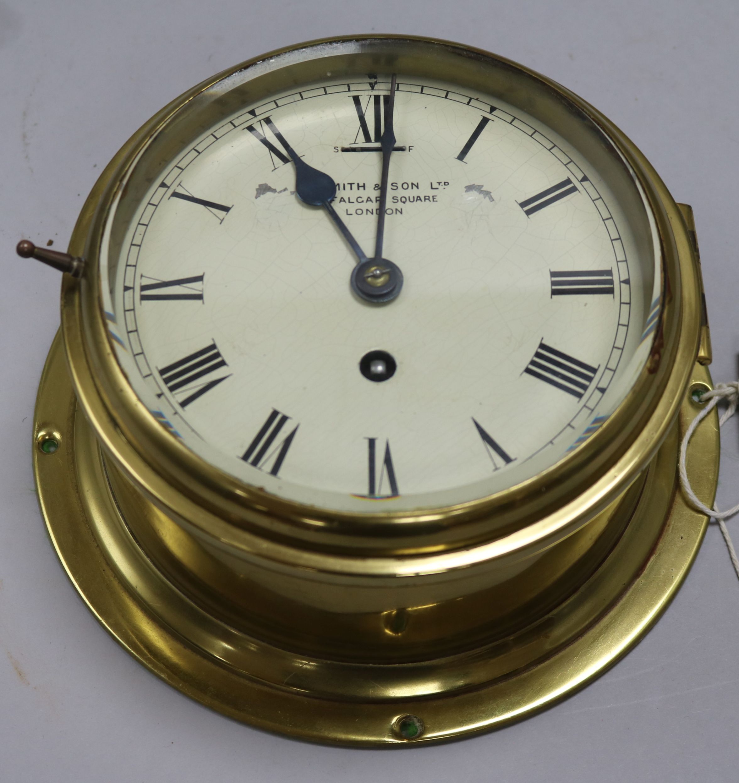 An Edwardian brass eight day bulkhead timepiece