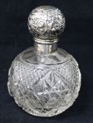 An Edwardian silver topped cut glass scent bottle, 12.5cm.