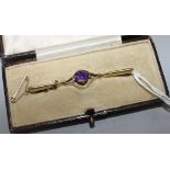 An early 20th century 15ct gold and amethyst bar brooch, 56mm.