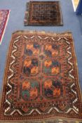 A Persian rust ground rug and a saddlebag, 130 x 100cm