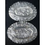 A pair of late 18th century Augsburg small silver oval plaques, embossed with cherubs, masks and