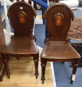 A pair of William IV oak hall chairs