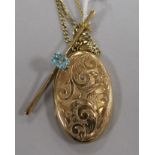 A 9ct gold bar brooch set with a topaz and a 9ct gold engraved oval locket on 9ct gold chain, 18.2gt