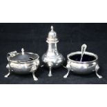 A three piece silver cruet set.