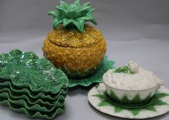 A Majolica cauliflower tureen, green leaf plates and pineapple bowl and cover