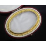 A 19th century glazed oval miniature frame in fitted red leather case, 75mm.