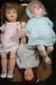 An Armand Marseille 990 character baby doll, bisque head and jointed composition body and two girl