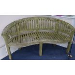 A curved garden bench, W.161cm