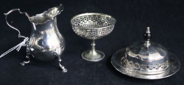 A silver cream jug and two plated items.