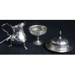 A silver cream jug and two plated items.