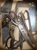 A collection of steel scissors and brass inlaid set squares