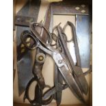 A collection of steel scissors and brass inlaid set squares