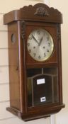 A 1930's oak wall clock, H.63cm