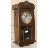 A 1930's oak wall clock, H.63cm