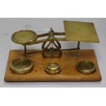 A set of mahogany and brass postal scales and weights