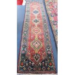 A Persian blue and russett runner, 325 x 77cm