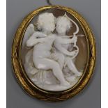 A Victorian yellow metal mounted cameo brooch, carved with Cupids, 62mm.