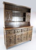 A 17th century style oak dresser, with geometric moulded drawers and cupboard doors, W.6ft D.1ft