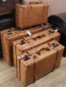 A stack of four pigskin suitcases, Largest W.75cm