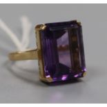 A yellow metal and emerald cut amethyst dress ring, size O.