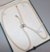 A single strand cultured pearl necklace with gem set adjustable clasp above two drops, 80cm approx.