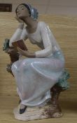 A Lladro figure of a girl with book