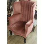 A barrel back upholstery armchair, castors off