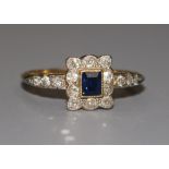 An 18ct gold sapphire and diamond tablet ring, with diamond set shoulders, size T.