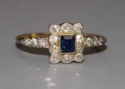 An 18ct gold sapphire and diamond tablet ring, with diamond set shoulders, size T.
