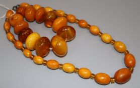 A single strand graduated oval amber bead necklace with spacers and an amber bead bracelet, gross