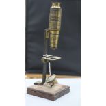 A 19th century folding sun dial and a compound microscope