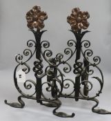 A pair of Arts & Crafts wrought iron and copper fire dogs