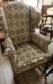 An upholstered wing back armchair