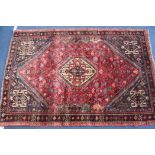 An Iranian red ground rug, 165 x 113cm