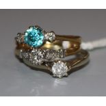An 18ct gold, blue zircon and diamond three stone ring and two other diamond rings, one 18ct and one