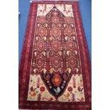 A Persian Kazah red ground rug, 200 x 100cm