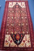 A Persian Kazah red ground rug, 200 x 100cm