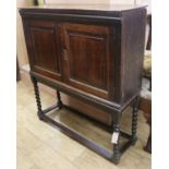 An oak cupboard on barley twist legs W.96cm