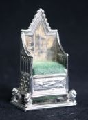 An Edwardian novelty silver pin cushion modelled as a Coronation chair by Levi & Salaman,